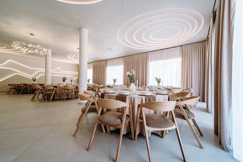 Sala Mi Amore z okrągłymi stołami i dekoracyjnym oświetleniem